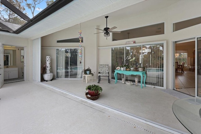 view of patio featuring ceiling fan and a lanai