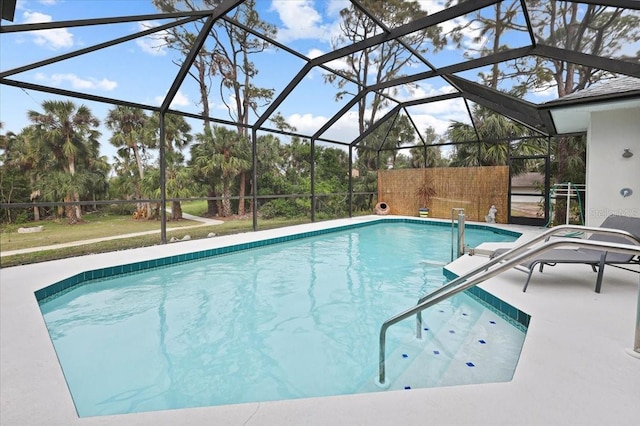 outdoor pool with glass enclosure and a patio area