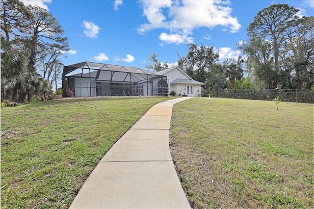 exterior space with a front yard, glass enclosure, and fence