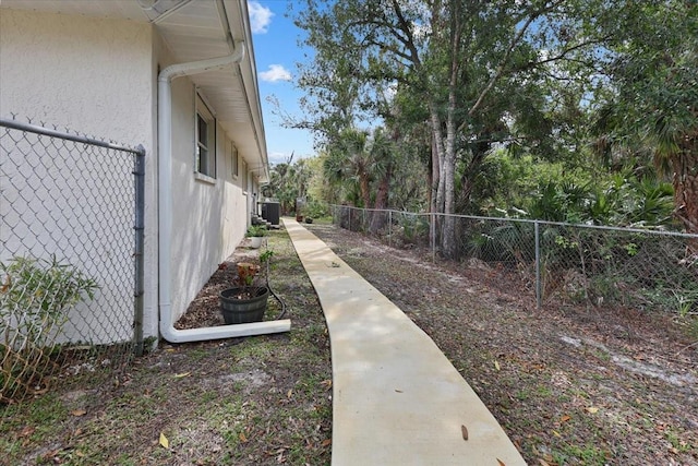 view of yard with central AC unit and a fenced backyard