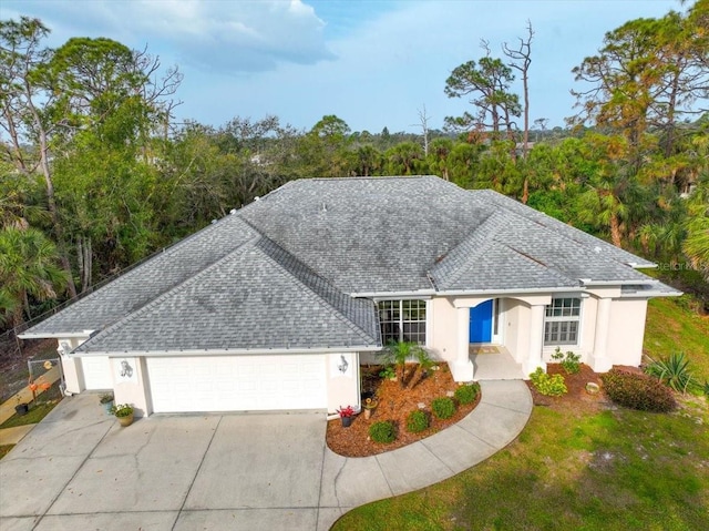 single story home featuring a garage, stucco siding, driveway, and roof with shingles