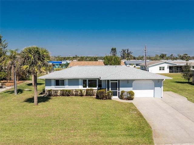 ranch-style house featuring a garage, concrete driveway, roof with shingles, stucco siding, and a front yard