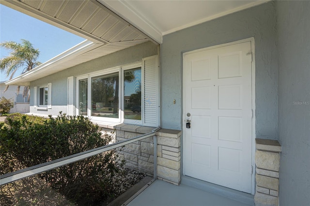 property entrance with stucco siding