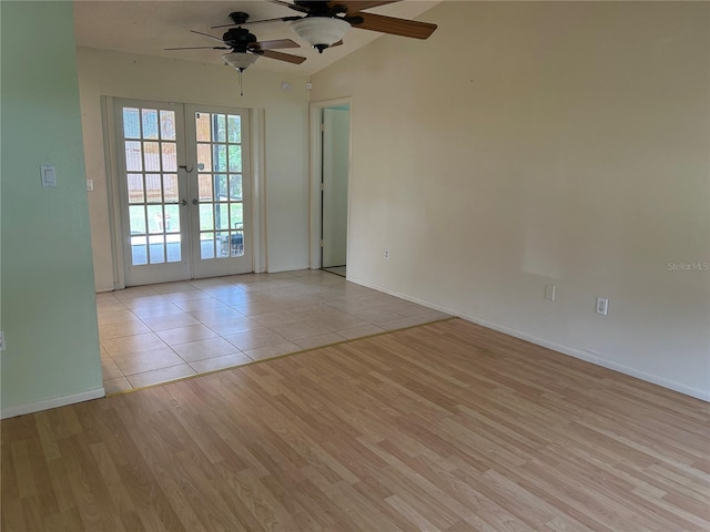 unfurnished room featuring lofted ceiling, french doors, baseboards, and light wood finished floors