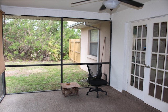 unfurnished sunroom featuring ceiling fan