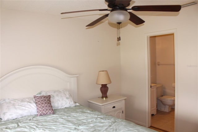 bedroom with ensuite bath and a ceiling fan