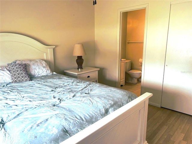 bedroom with wood finished floors and ensuite bathroom