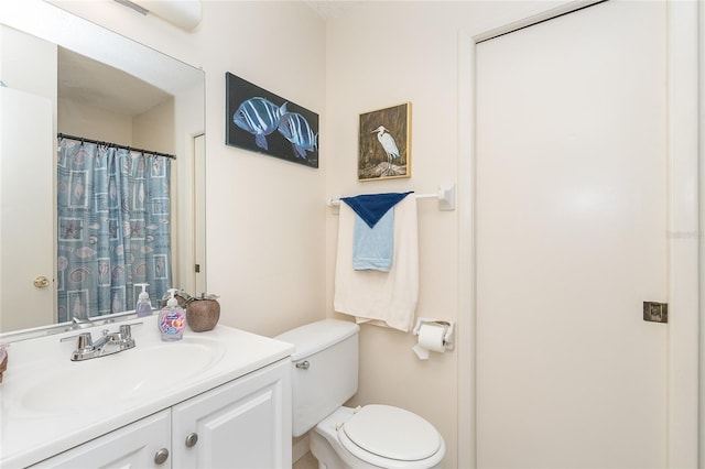 full bathroom with toilet and vanity