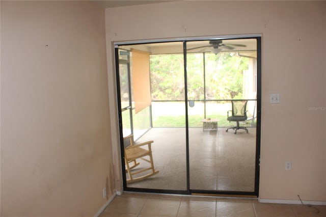 doorway with baseboards and light tile patterned floors