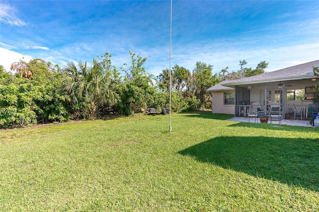 view of yard with a patio and ceiling fan