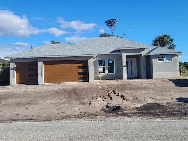 contemporary house with roof with shingles and stucco siding