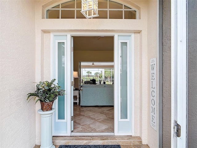 view of exterior entry with stucco siding