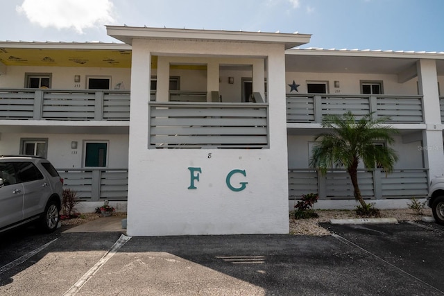 view of property featuring uncovered parking