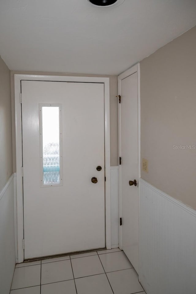 entryway featuring a wainscoted wall and light tile patterned floors