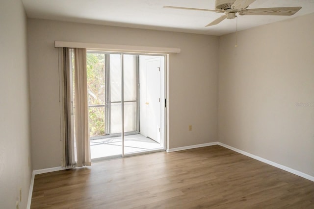 spare room featuring a ceiling fan, baseboards, and wood finished floors