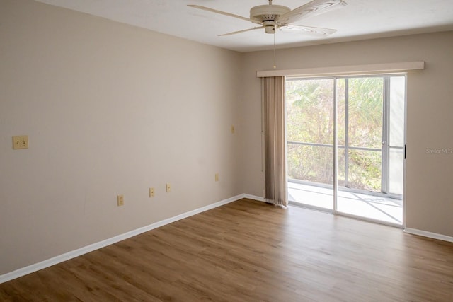 spare room featuring ceiling fan, wood finished floors, and baseboards