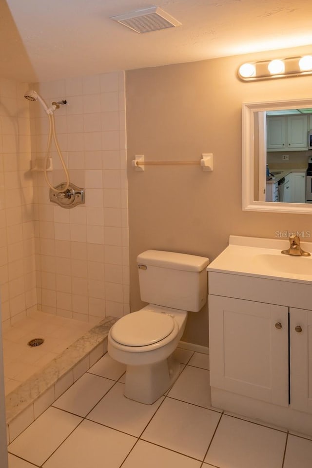 bathroom featuring visible vents, tile patterned flooring, a shower stall, and toilet