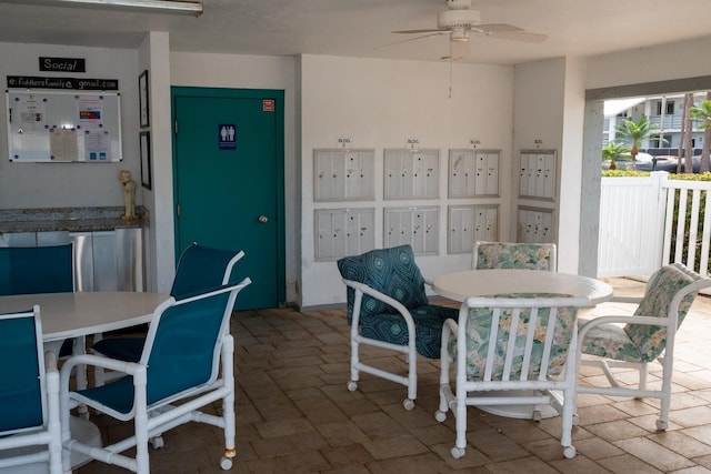 dining room with ceiling fan and mail area