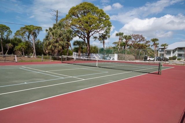 view of tennis court featuring fence