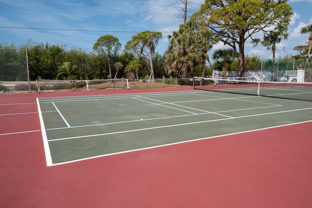 view of tennis court with fence