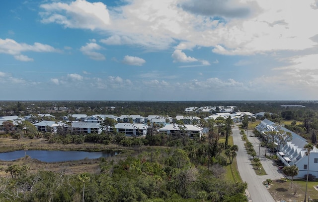 drone / aerial view featuring a residential view and a water view