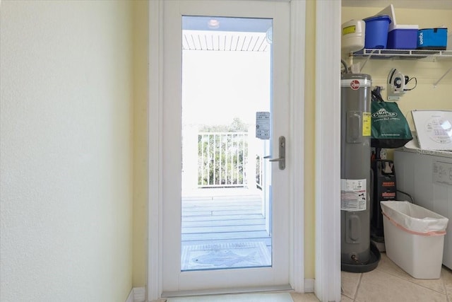 entryway featuring tile patterned flooring and electric water heater