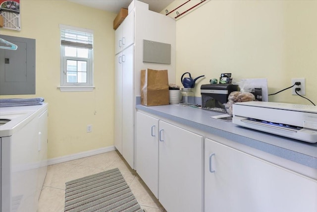 washroom with washing machine and clothes dryer, light tile patterned floors, laundry area, electric panel, and baseboards