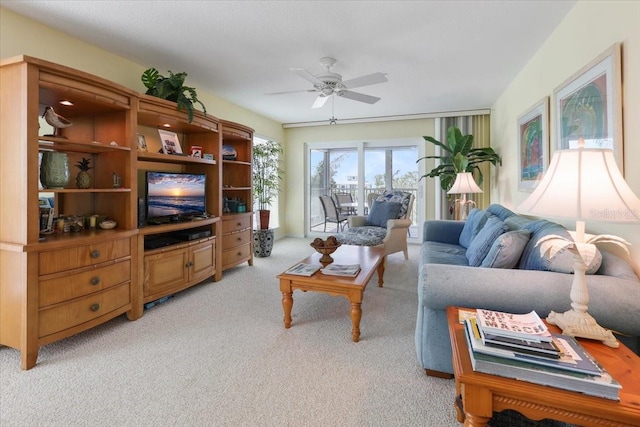 living area featuring light colored carpet and ceiling fan