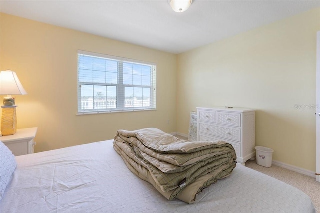 bedroom featuring carpet and baseboards