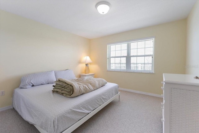 bedroom featuring carpet and baseboards