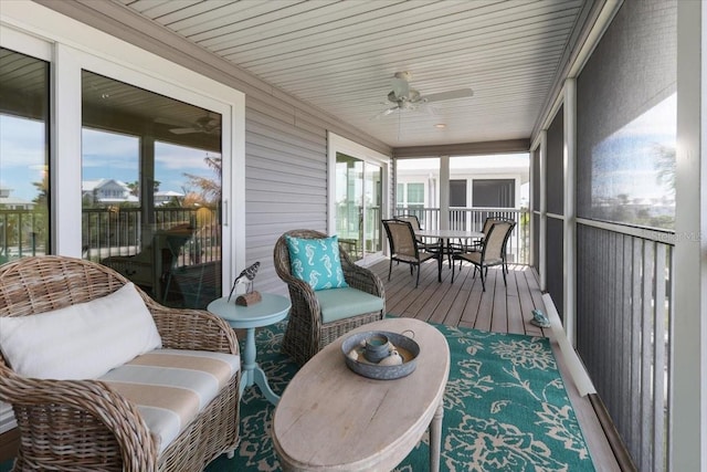 sunroom with ceiling fan and a wealth of natural light