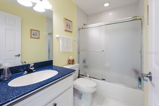 full bathroom featuring toilet, tile patterned floors, bath / shower combo with glass door, and vanity