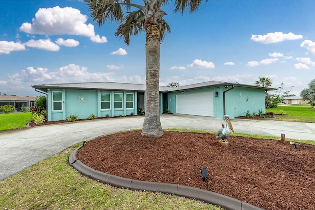 view of front facade with concrete driveway, an attached garage, and stucco siding