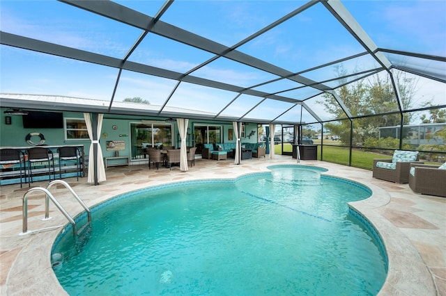 outdoor pool featuring glass enclosure, a patio, and an outdoor hangout area