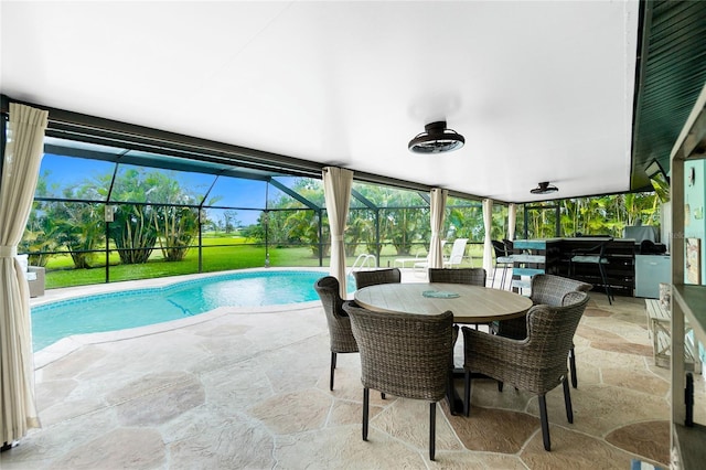 exterior space with outdoor dining space, a lanai, and an outdoor pool