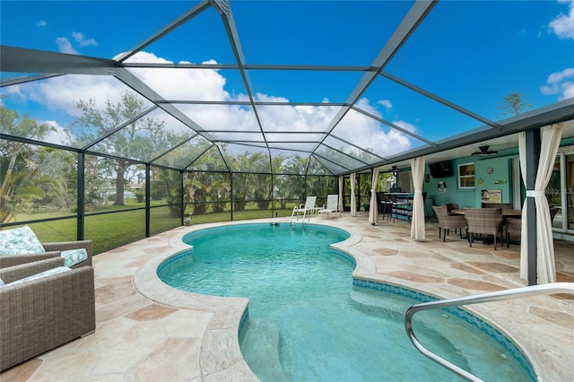 pool featuring outdoor dining area, a patio, an outdoor hangout area, glass enclosure, and ceiling fan