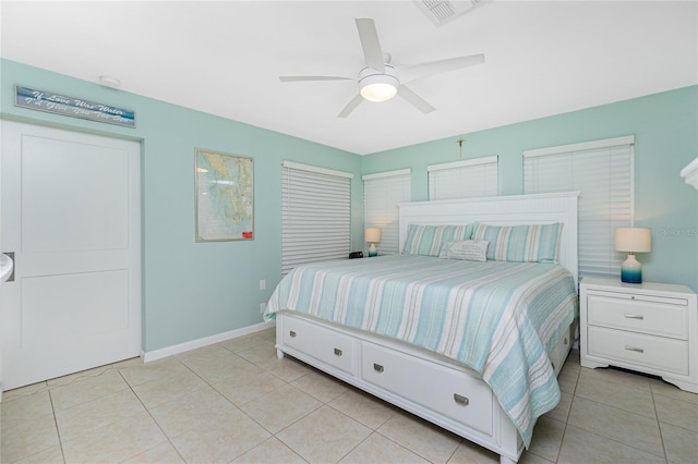 bedroom with light tile patterned floors, ceiling fan, visible vents, and baseboards