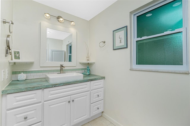 bathroom featuring tile patterned floors, baseboards, and vanity