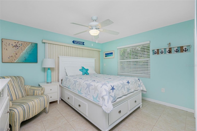 bedroom with light tile patterned floors, ceiling fan, and baseboards