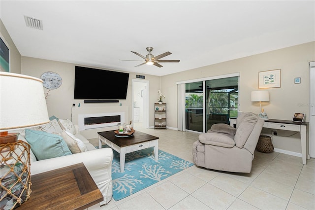 living area featuring light tile patterned floors, ceiling fan, a fireplace, and visible vents