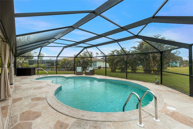 outdoor pool featuring a yard, a patio area, and glass enclosure