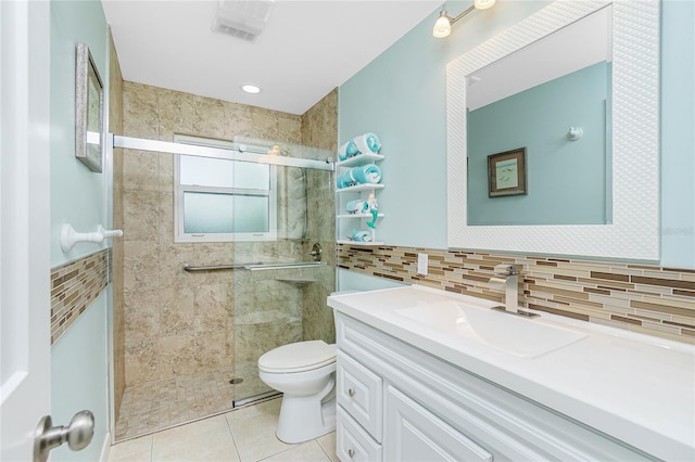 full bath featuring toilet, tile patterned flooring, a shower stall, and tile walls