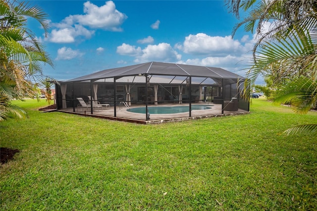 pool featuring a patio area, glass enclosure, and a yard