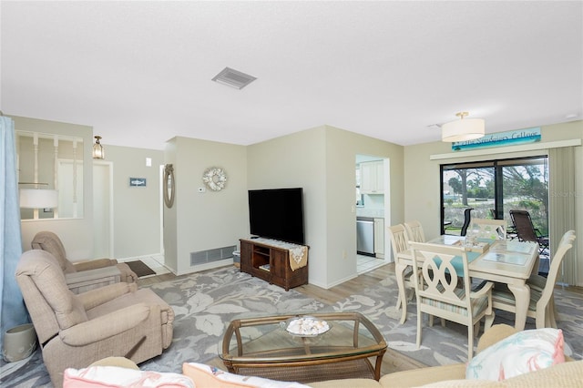 living area featuring visible vents and baseboards