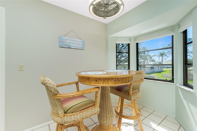 dining space with light tile patterned floors and baseboards