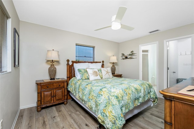 bedroom featuring light wood-style flooring, visible vents, ceiling fan, and baseboards