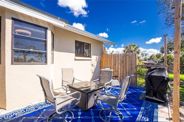 view of patio featuring grilling area and fence