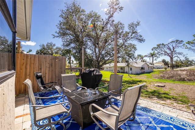 view of patio / terrace featuring a fire pit and fence