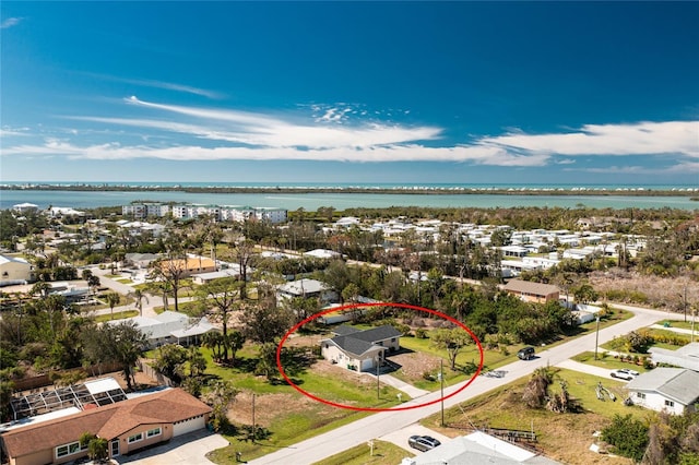 birds eye view of property with a water view and a residential view