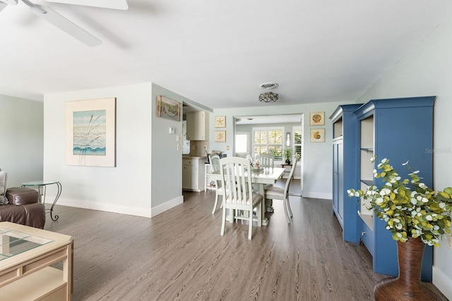 dining space featuring baseboards, visible vents, and wood finished floors